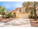 Two-story home with desert landscaping, an attached two-car garage, and a red tile roof at 1742 Ashburn Dr, North Las Vegas, NV 89032