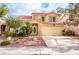 Two-story home with desert landscaping, an attached two-car garage, and a red tile roof at 1742 Ashburn Dr, North Las Vegas, NV 89032