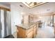 Kitchen view features wood cabinets, granite countertops, stainless appliances, and adjacent dining area at 1742 Ashburn Dr, North Las Vegas, NV 89032