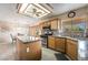 Bright kitchen features wood cabinetry, granite countertops, and a center island with stainless appliances at 1742 Ashburn Dr, North Las Vegas, NV 89032