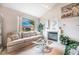 Comfortable living room with a fireplace and a large window with a view of the front yard at 1742 Ashburn Dr, North Las Vegas, NV 89032