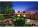 Backyard showcasing desert landscaping, a wooden shed and a tiled roof home with a covered patio at 1929 Stonington Pl, Las Vegas, NV 89108