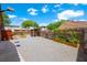 Large gravel backyard with a shed, garden boxes, and ample space for outdoor activities at 1929 Stonington Pl, Las Vegas, NV 89108