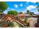 Multi-tiered backyard boasts a storage shed, mature trees, and a charming brick pathway at 1929 Stonington Pl, Las Vegas, NV 89108