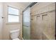 Modern bathroom featuring a glass shower with mosaic tile accents, built-in shelf, and shower seat at 1929 Stonington Pl, Las Vegas, NV 89108