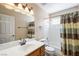 Well-lit bathroom featuring a vanity, a bathtub with a shower, and a striped shower curtain at 1929 Stonington Pl, Las Vegas, NV 89108