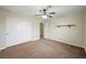 Spacious bedroom with plush carpet, double closets, ceiling fan and access to an attached room at 1929 Stonington Pl, Las Vegas, NV 89108
