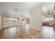 Open-concept living area featuring tile flooring, large windows, and seamless flow into the adjacent kitchen at 1929 Stonington Pl, Las Vegas, NV 89108