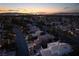 Picturesque aerial view showing a neighborhood at twilight with city lights on the horizon at 2108 Inverness Dr, Henderson, NV 89074
