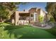 Beautiful backyard featuring a putting green, covered patio, and lush landscaping at 2108 Inverness Dr, Henderson, NV 89074
