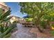 Backyard patio with lush landscaping creates a private outdoor dining area at 2108 Inverness Dr, Henderson, NV 89074