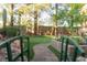 Lush backyard with a mini-golf course and mature trees in a serene setting at 2108 Inverness Dr, Henderson, NV 89074