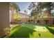 Private backyard with a putting green, mature trees, and well-maintained landscaping at 2108 Inverness Dr, Henderson, NV 89074