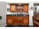Stylish bar area features wood cabinets, granite countertops, and a built-in display shelf at 2108 Inverness Dr, Henderson, NV 89074