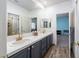 Bright bathroom featuring a double vanity with white countertops and gray cabinets plus wood style flooring at 2108 Inverness Dr, Henderson, NV 89074