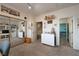 Spacious bedroom with mirror closet doors and access to an additional room, well lit with neutral walls at 2108 Inverness Dr, Henderson, NV 89074
