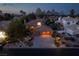 An exterior evening view showcases beautiful landscaping, a well-lit facade, and a two-car garage at 2108 Inverness Dr, Henderson, NV 89074