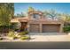Well-maintained home featuring a two-car garage, desert landscaping, and a symmetrical front facade at 2108 Inverness Dr, Henderson, NV 89074