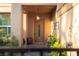 Inviting front entrance featuring a decorative door with glass panel and stone accents surrounded by lush greenery at 2108 Inverness Dr, Henderson, NV 89074