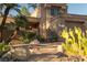Charming front exterior with desert landscaping, stone pathway, and a gated entrance to a private courtyard at 2108 Inverness Dr, Henderson, NV 89074