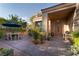 Charming front porch with a paved stone patio and outdoor dining under a shady umbrella at 2108 Inverness Dr, Henderson, NV 89074