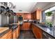 Modern kitchen with stainless steel appliances, granite countertops, and custom wood cabinetry at 2108 Inverness Dr, Henderson, NV 89074