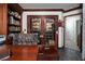 Warm home office features custom shelving, a large desk, and French doors at 2108 Inverness Dr, Henderson, NV 89074