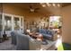Covered patio area with comfortable seating, ceiling fans, and access to the backyard at 2108 Inverness Dr, Henderson, NV 89074