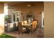 Covered patio with an outdoor dining table and a comfortable seating area for entertaining at 2108 Inverness Dr, Henderson, NV 89074