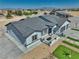 Bird's eye view showcasing the ranch house's well manicured lawn, landscaping and gravel lot at 2650 Underbrush Ave, Pahrump, NV 89048