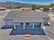 Expansive backyard, concrete covered patio and well-maintained landscaping in aerial shot of a ranch home at 2650 Underbrush Ave, Pahrump, NV 89048