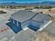 Aerial view of an updated ranch-style house with a large lot and mountain views at 2650 Underbrush Ave, Pahrump, NV 89048