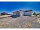 Spacious backyard featuring desert landscaping and a covered patio, perfect for outdoor entertaining at 2650 Underbrush Ave, Pahrump, NV 89048