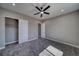 Bedroom features a ceiling fan, plush carpet, and a closet at 2650 Underbrush Ave, Pahrump, NV 89048