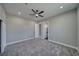 Spacious bedroom with soft gray walls and a modern ceiling fan with a walk in bathroom at 2650 Underbrush Ave, Pahrump, NV 89048
