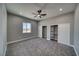 Spacious bedroom with soft gray walls, two closets and a modern ceiling fan at 2650 Underbrush Ave, Pahrump, NV 89048