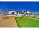 Inviting single-story home with a neatly landscaped front yard showcasing desert landscaping and lush green grass at 2650 Underbrush Ave, Pahrump, NV 89048