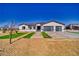 Charming single-story home featuring a modern design with a well-manicured lawn and spacious driveway at 2650 Underbrush Ave, Pahrump, NV 89048