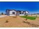 Stylish single-story home with desert landscaping, complemented by green grass accents and modern design elements at 2650 Underbrush Ave, Pahrump, NV 89048