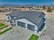 New construction home with a gray roof, two-car garage and landscaped front yard in a desert neighborhood at 2650 Underbrush Ave, Pahrump, NV 89048