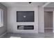 Living room featuring a modern fireplace, shiplap wall, and large television screen at 2650 Underbrush Ave, Pahrump, NV 89048