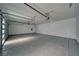 Clean garage featuring epoxy flooring, two automatic garage door openers, and white painted walls at 2650 Underbrush Ave, Pahrump, NV 89048