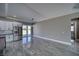 Bright and airy kitchen with gray tile floors and stainless steel refrigerator at 2650 Underbrush Ave, Pahrump, NV 89048