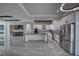 Large kitchen with gray island, stainless appliances, wine storage, and bar area at 2650 Underbrush Ave, Pahrump, NV 89048