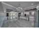 Open-concept living space features tile floors, a gourmet kitchen, and modern lighting at 2650 Underbrush Ave, Pahrump, NV 89048