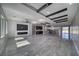 Open-concept living room with a fireplace, beverage bar, stylish ceiling and shiny tile floors at 2650 Underbrush Ave, Pahrump, NV 89048
