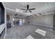 Spacious living room with an open layout, ceiling fan, and shiny tile floors at 2650 Underbrush Ave, Pahrump, NV 89048
