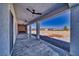 Inviting covered patio with ceiling fans, a modern fireplace, and panoramic views of the surrounding landscape at 2650 Underbrush Ave, Pahrump, NV 89048