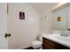 Powder bathroom features a white sink and toilet and decorative signs hanging on the wall at 2696 Matogroso Ln, Las Vegas, NV 89121