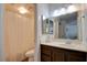 Bathroom showcasing a shower with curtain, a toilet and vanity, all brightly illuminated at 2696 Matogroso Ln, Las Vegas, NV 89121